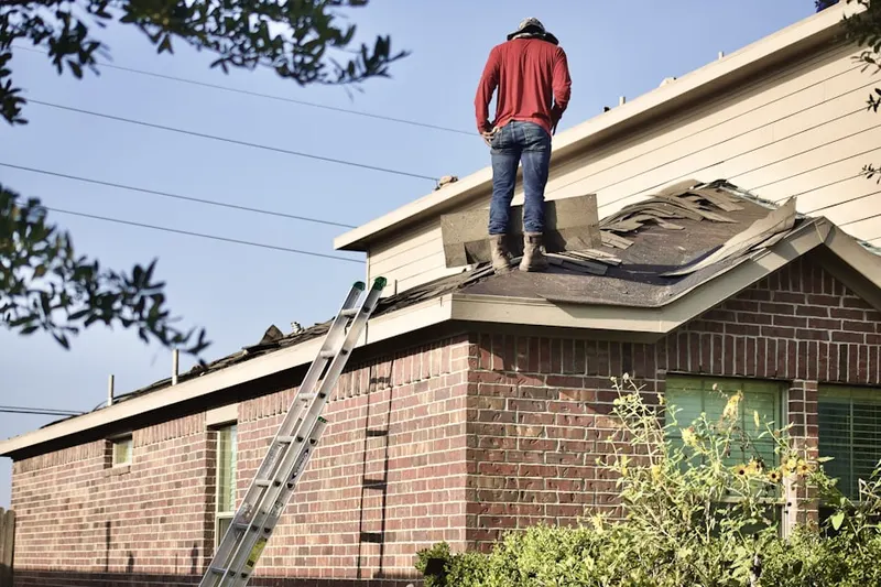 Professional roofer working on a residential roof in Hayden